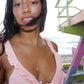 black woman with straight hair on beach with pink bikini wearing the 7 diamond love knot necklace from the wandering jewel