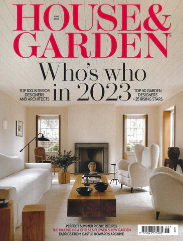 cove of house and Garden magazine featuring jewelry from the wandering jewelring a white modern Scandinavian living room andatu