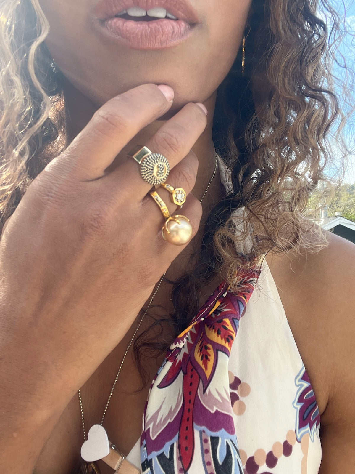 Black woman with long brown hair wearing a the Gold 8 sided octagon infinity ring with an eight ball inscribed in black diamonds from the wandering jewel