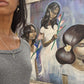 woman in gray top in front of mural wearing two 7 diamond crosses from the wandering jewel