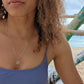 woman in purple bikini on beach wearing the 7 diamond star of David pendant necklace from the wandering jewel