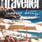 cover of Conde Nast Traveller magazine featuring white umbrellas and lounge chairs on a beach and jewelry from the wandering jewel