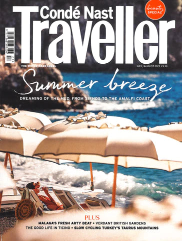 cover of Conde Nast Traveller magazine featuring white umbrellas and lounge chairs on a beach and jewelry from the wandering jewel