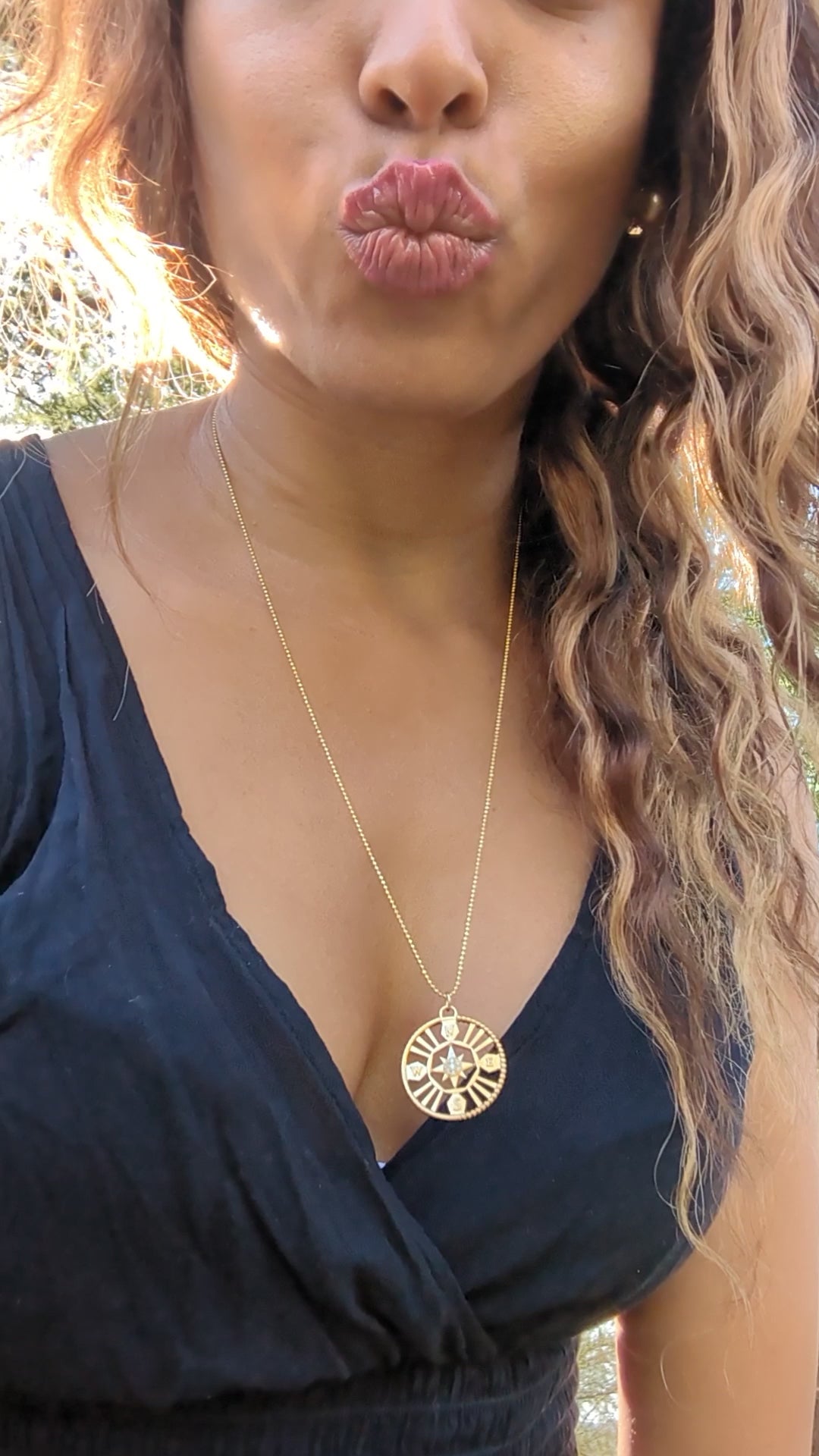 video of black woman with curly hair wearing the 7 diamond compass necklace from the wandering jewel