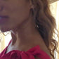 video of woman in pink dress in front of a window wearing the diamond Pentagon Stud earrings from the wandering jewel