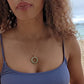 video of black woman in purple bikini on beach wearing the 18K Solid Rose Gold green jade ring on rose gold necklace from the wandering jewel