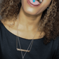 woman with pill in her mouth wearing drug dealer nameplate pendant necklace from the wandering jewel