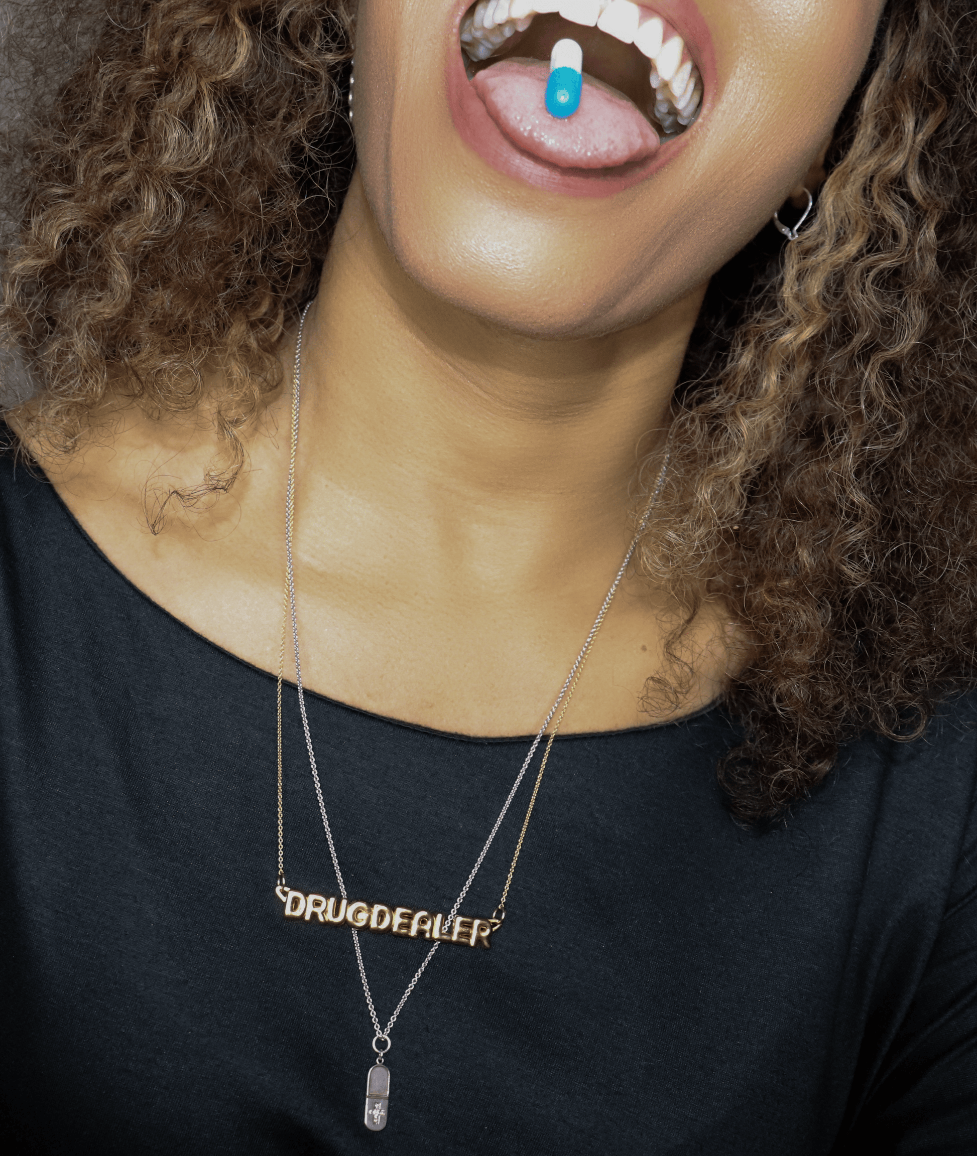 woman with pill in her mouth wearing drug dealer nameplate pendant necklace