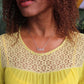 woman in yellow dress wearing mutha necklace