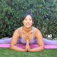 woman doing yoga splits and wearing two white jade ring necklaces