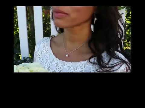 bride with white rose wearing the white south sea pearl pendant from the wandering jewel