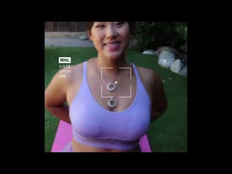 video of woman doing yoga splits and wearing two white jade ring necklaces from the wandering jewel