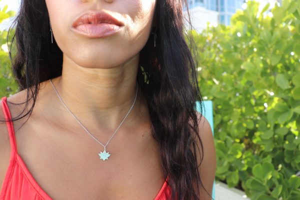 woman in orange top wearing 7 diamond lotus necklace from the wandering jewel