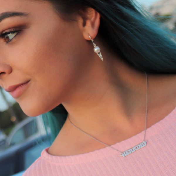 woman in pink shirt wearing the herkind nameplate necklace from the wandering jewel