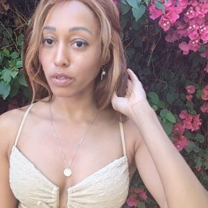 woman in tan bikini with long brown hair wearing the 7 diamond star of david pendant by the wandering jewel