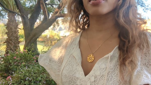 black woman in white dress in forrest wearing the 7 diamond pendant necklace from the wandering jewel