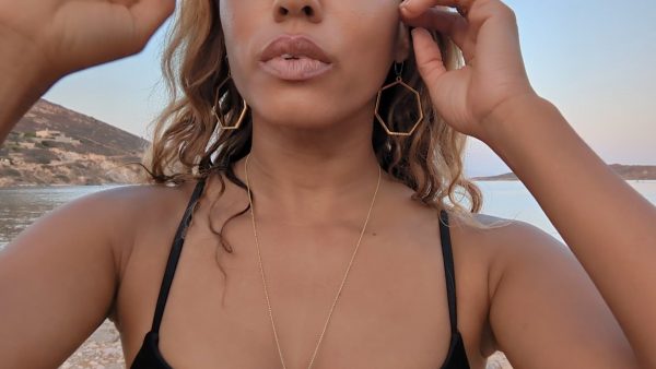 woman in black bikini on beach wearing Large gold hoop diamond earrings septagon shaped from the wandering jewel