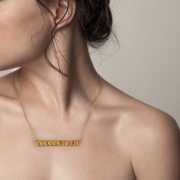 Woman wearing nameplate necklace that says drug dealer from the wandering jewel