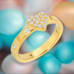 Gold and diamond Disengagement Ring with the word fuck off engraved, the ring also features a Gold heart in the middle of the ring