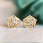 Gold Pentagon shaped diamond stud earrings from the wandering jewel