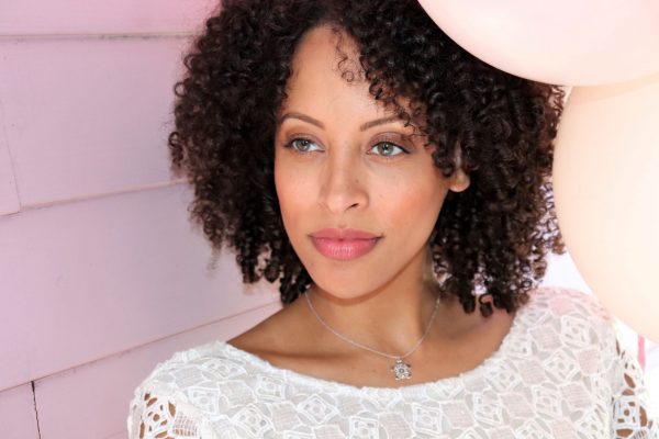 Woman wearing diamond turtle necklace from the wandering jewel and white lace dress