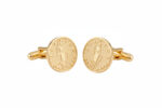 Gold Lady Justice cufflinks from the wandering jewel set against a white background