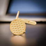 gold Heart patterned cufflinks on a desk in a workplace setting from the wandering jewel