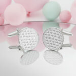silver tiny heart patterned cufflinks from the wandering jewel on a mirrored table with pastel balloons in the background