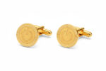 Gold power button cufflinks from the wandering jewel set against a white background