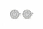 Silver power button cufflinks from the wandering jewel set against a white backdrop