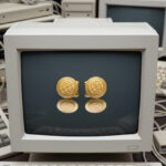 Gold www Interweb symbol cufflinks from the wandering jewel surrounded by old Apple computers and keyboards