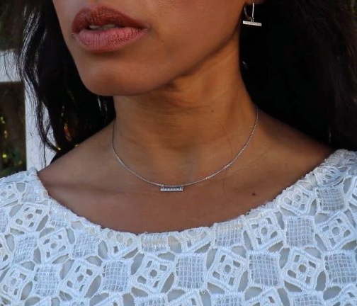 Diamond-set number 7 necklace sparkling under soft light