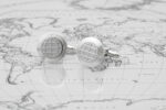 Interweb www cufflinks on the face in silver resting on a map of the world